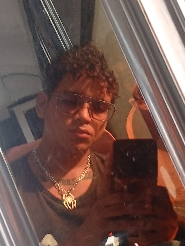 Person documents selfie session with spider pendant in Venezuela
