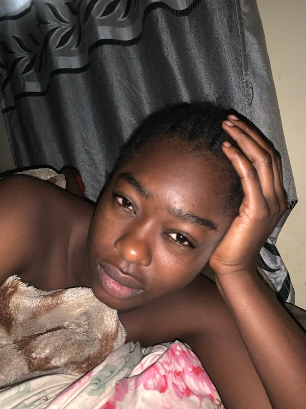 Person resting on patterned bedding in Rafin Par, Nigeria