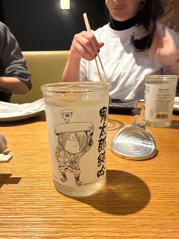 Person enjoys ramen dinner at wooden table in New York