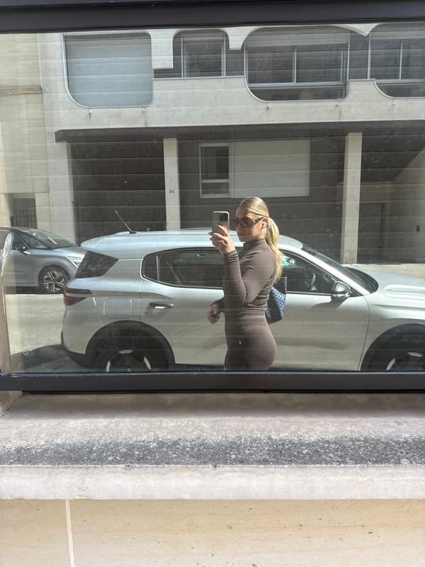 Woman takes selfies in Paris on sunny afternoon