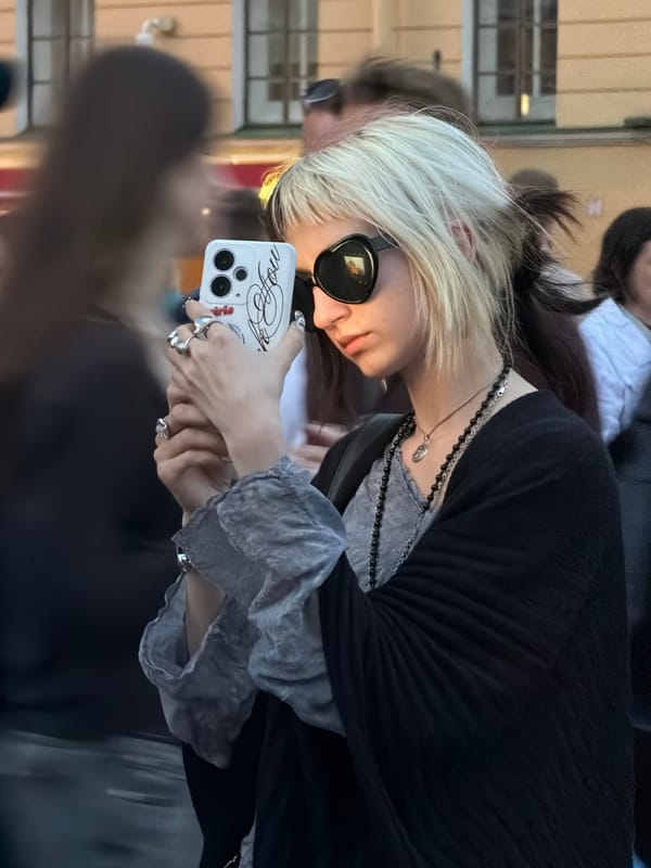 Selfie in sunglasses and a ruffled grey layered top