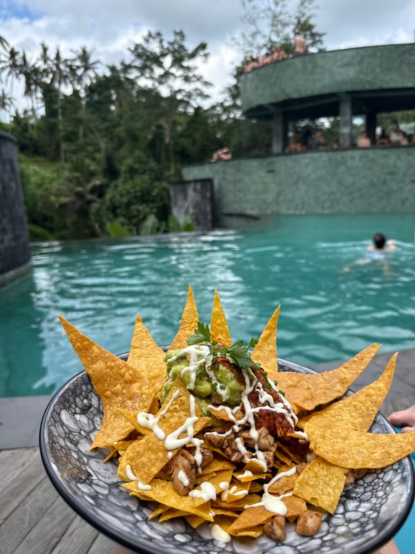 Tourist documents poolside meal at Tegallalang resort, Indonesia