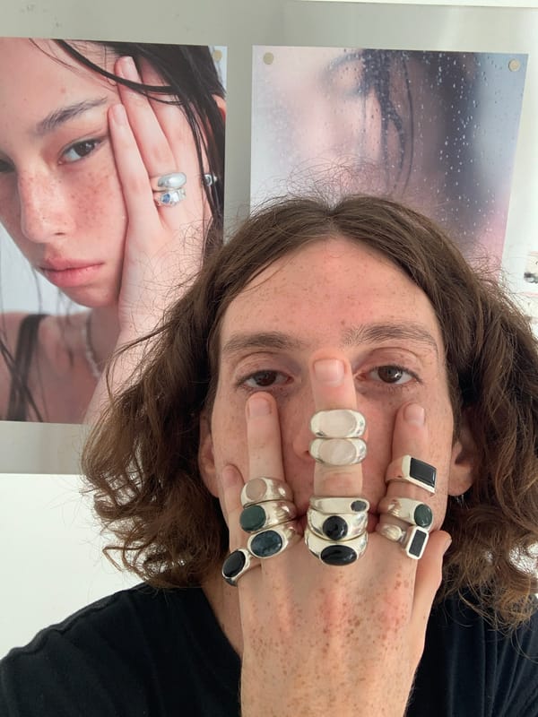 Person poses with silver rings at Buenos Aires photo display