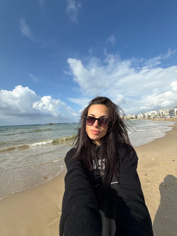Woman takes beach selfies in Chania, Greece