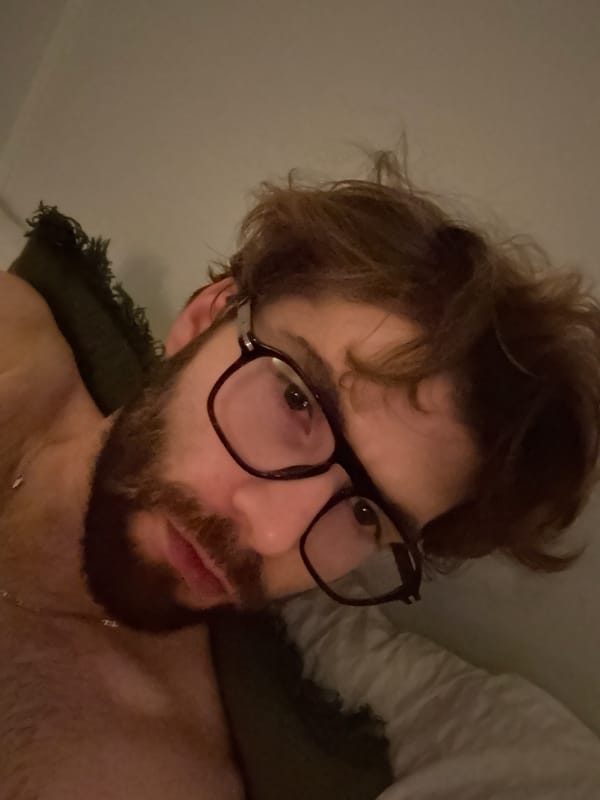 Man photographed in candlelit Montreal bedroom early morning