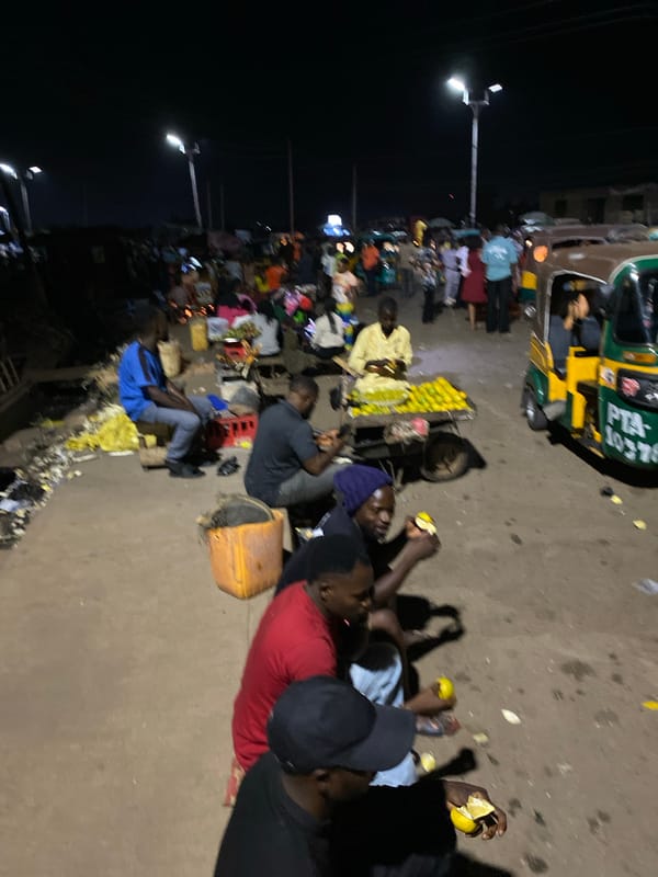 Nighttime fruit vendors serve customers in Bukuru, Nigeria