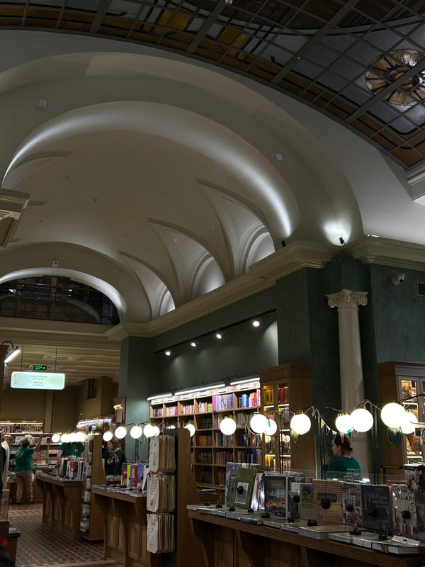 Woman browses books in grand Saint Petersburg bookstore