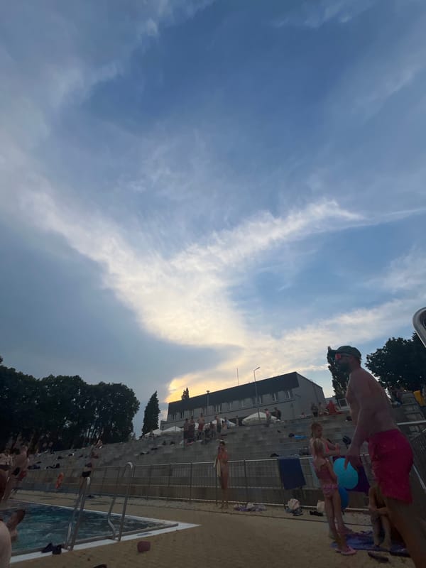 Crowded public pool on a cloudy summer afternoon