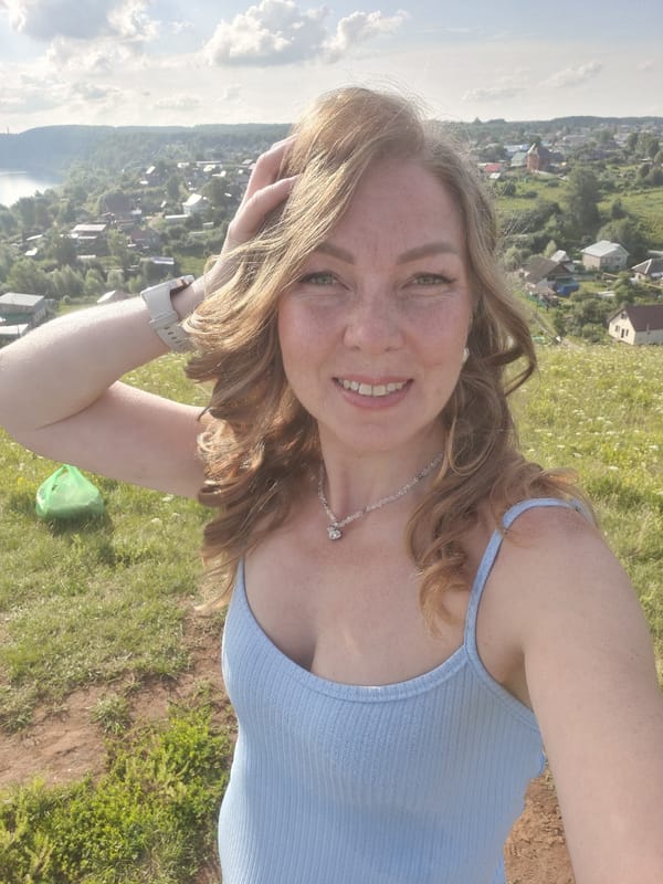 Family outing on a hilltop overlooking the river in Olkhovka