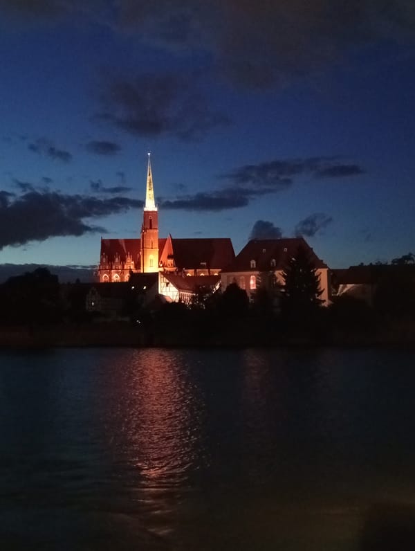 Wrocław's Oder waterfront lit up on a summer evening