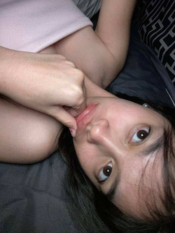 Woman rests on bed in Panabo, Philippines