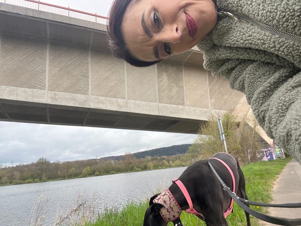 Woman takes selfie with dog near Konz Bridge