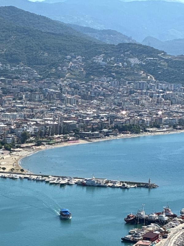 Alanya from above: castle ruins, harbor, and coastline on a summer morning