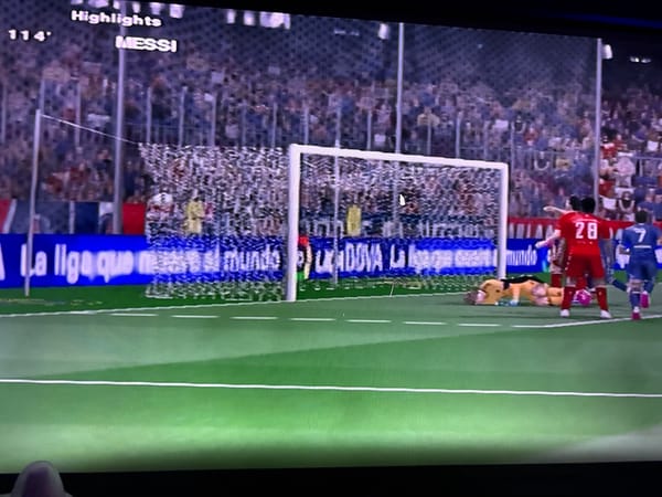 Football game highlights featuring Messi and Lewandowski on screen