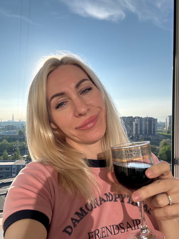 Woman enjoys wine on city balcony during sunny afternoon