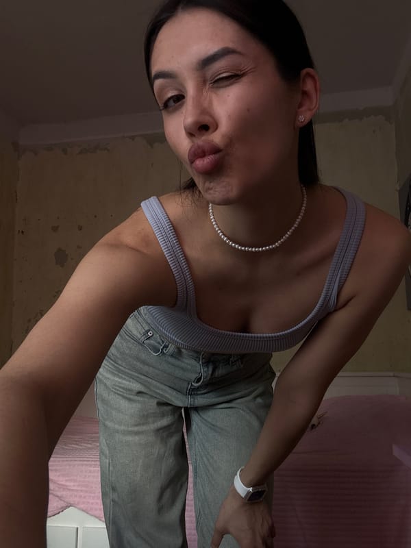 Woman takes selfie in dimly lit room in Votkinsk
