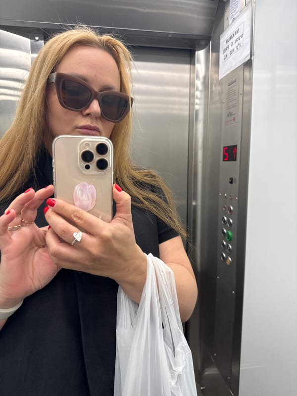 Woman photographs selfie and jewelry in Tel Aviv elevator