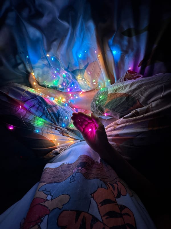 Person in bed with fairy lights in Ulyanovsk