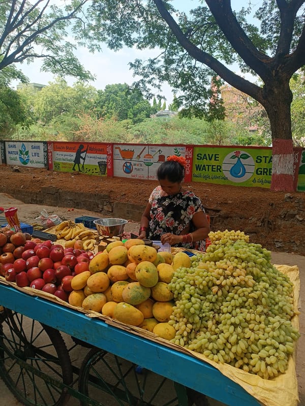 Street vendors sell fresh produce at Puttaparthi morning market