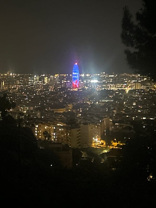 Barcelona building illuminated in blue and red at night