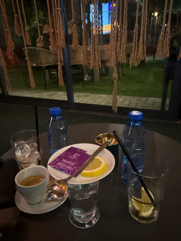 Evening cafe scene features ornate mosaic lamps in Yambol