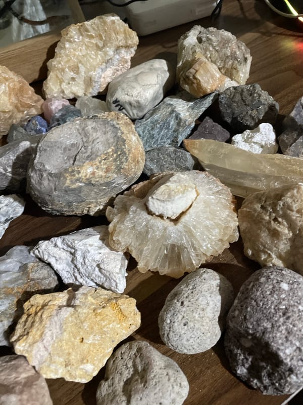 Rock collector displays mineral specimens on wooden surface in Davao