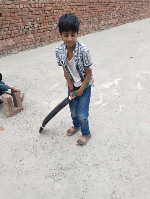 Boys handle bricks in early morning activity in Dera Chahal