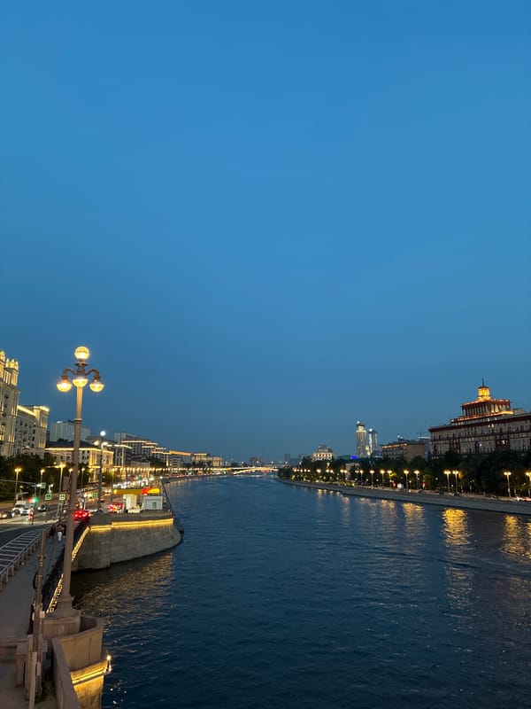 Nighttime Moscow cityscape captured showing river with light reflections