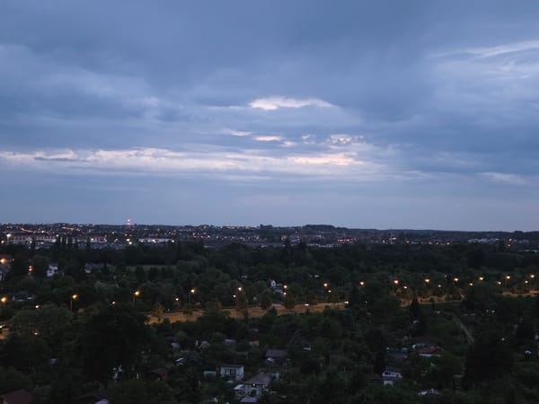 Dusk-to-night transition captured over Szczecin cityscape from elevated viewpoint