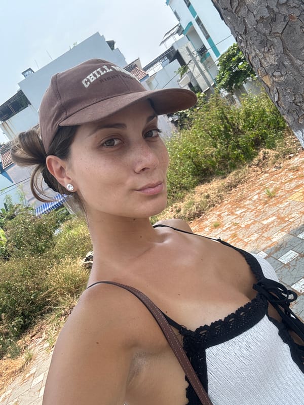 Woman takes morning selfies near parked car in Đà Nẵng