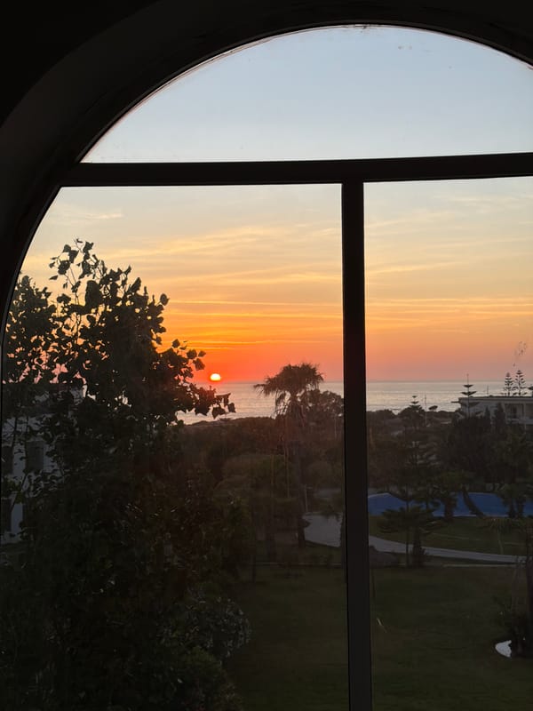 Sunset captured through arched window in Tangier, Morocco