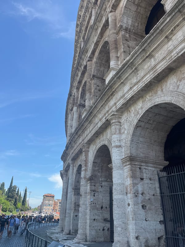 Tourist captures upward view of Colosseum's ancient stonework
