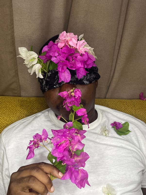 Person photographed resting with flowers in Accra artistic portrait session