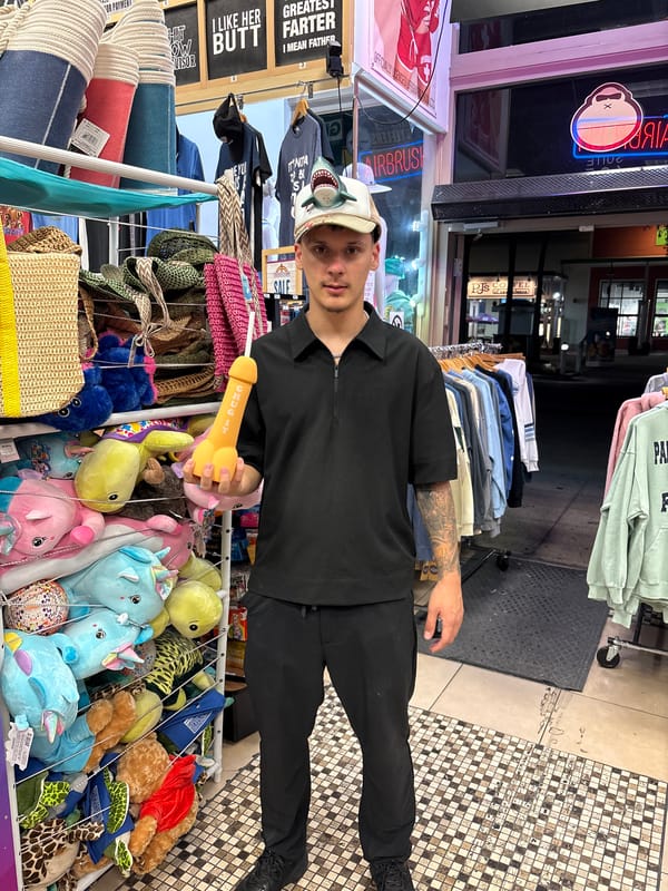 Man holds novelty toy outside Panama City Beach store