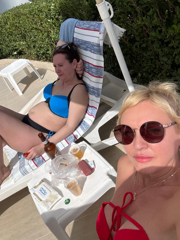 Women relax poolside on sunny afternoon