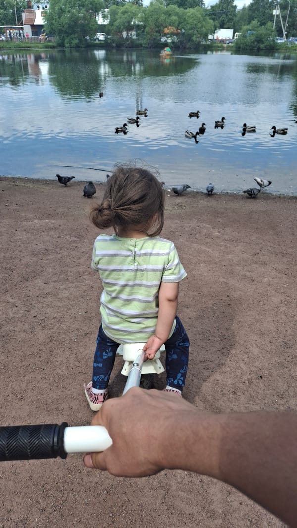 Child plays with toys near waterfront in Saint Petersburg