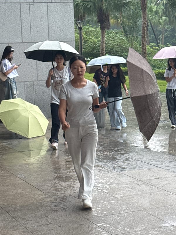 Rainy campus day in Jiangjin with outdoor crowds and indoor presentations.