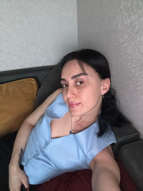 Woman rests on couch in Tbilisi afternoon