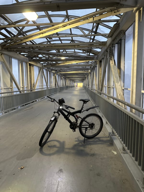 Mountain bike parked on enclosed pedestrian overpass in Moscow