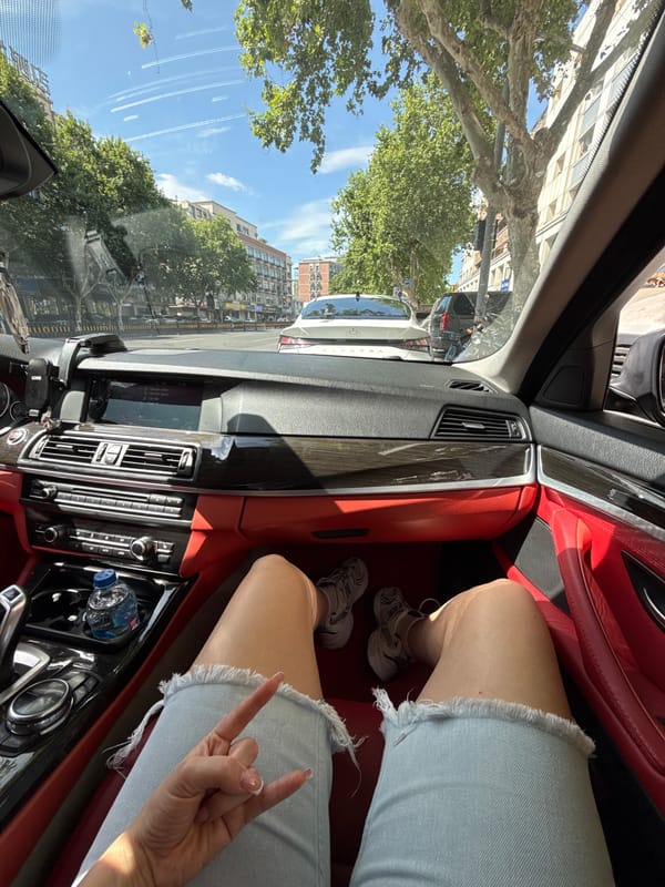 Person Makes Hand Gesture Inside Car in Yiwu