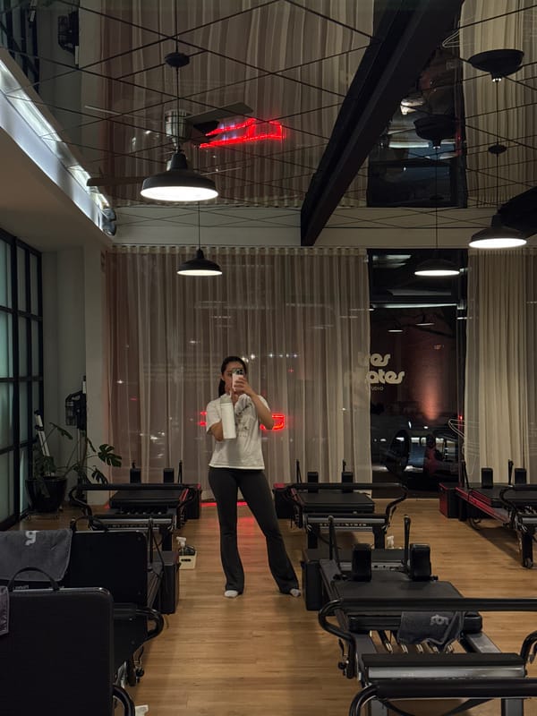 Woman documents evening Pilates workout session in Puebla studio