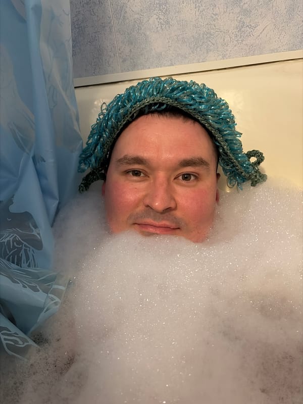 Man Takes Playful Bubble Bath Wearing Swimming Goggles in Izhevsk