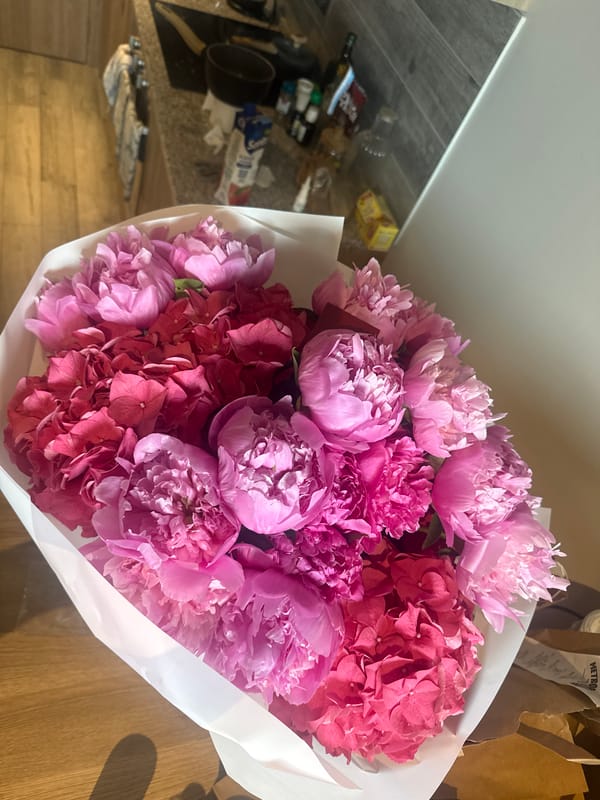 Colorful flower bouquet photographed on wooden surface in Milan