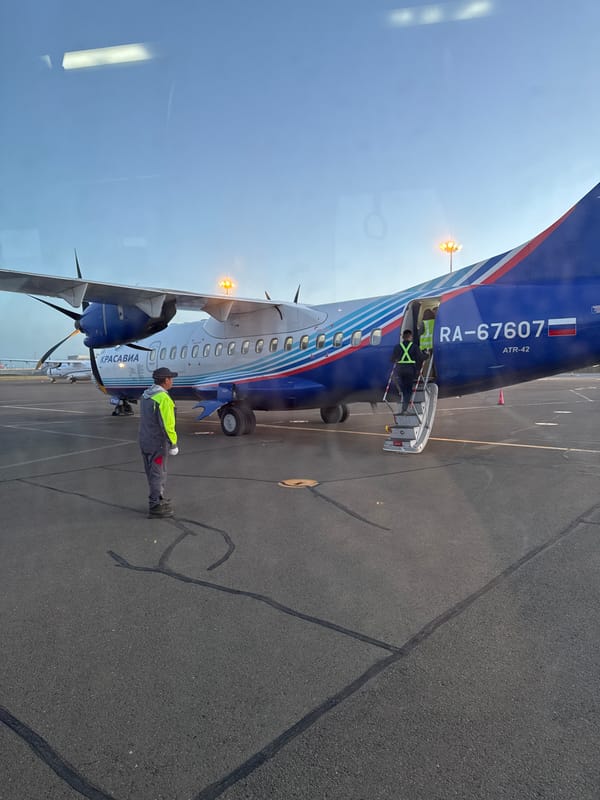 ATR-42 aircraft serviced by ground crew in Zuunmod, Mongolia