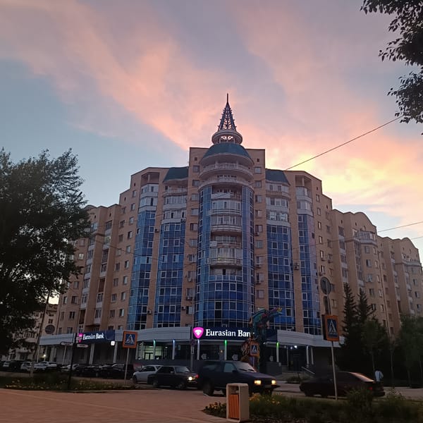 Kokshetau at dusk: streets, parks, and a bank building