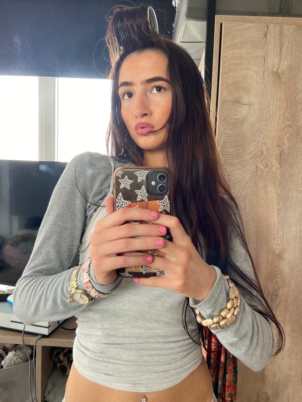 Woman takes selfies with hair roller in London