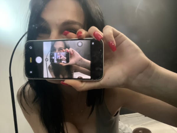 Woman documents afternoon selfie session with cat at home
