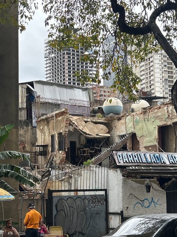 Crumbling apartment facades amid Caracas high-rises
