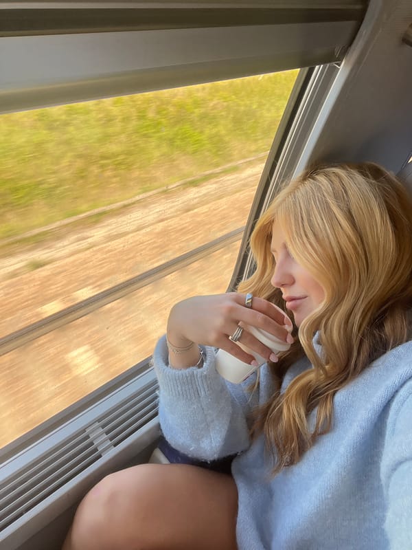 Woman rests with coffee during morning commute in Marmeaux