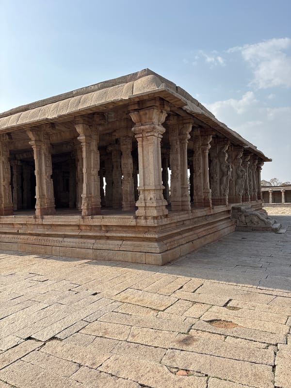 Tourist documents ancient temple carvings in Kamalapura, India